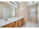 Bathroom with a large mirror over a double sink vanity and a glass enclosed shower at 1142 Heavenly Harvest Pl # 2, Henderson, NV 89002