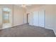 A carpeted bedroom with a ceiling fan and a closet with white sliding doors at 1142 Heavenly Harvest Pl # 2, Henderson, NV 89002