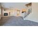 Bright living room with neutral carpet, fireplace, and easy access to the kitchen and staircase at 1142 Heavenly Harvest Pl # 2, Henderson, NV 89002