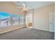 Spacious bedroom featuring high ceilings, three windows and an arched entry to an ensuite bathroom at 1142 Heavenly Harvest Pl # 2, Henderson, NV 89002