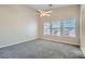 Serene bedroom with high ceilings, three windows, and neutral-colored carpet at 1142 Heavenly Harvest Pl # 2, Henderson, NV 89002