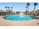 Inviting community pool area with lounge seating and palm trees, perfect for relaxation and recreation at 1142 Heavenly Harvest Pl # 2, Henderson, NV 89002