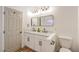 Modern bathroom featuring double sinks, quartz countertops, dark hardware, and ample lighting at 1183 Winnipeg Ct, Henderson, NV 89002