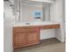 Bathroom featuring wooden cabinets and drawers with white countertops and a large mirror at 1701 E Katie Ave # 21, Las Vegas, NV 89119