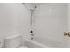 Well-lit bathroom with white tiled walls and floors and all white porcelain fixtures at 1701 E Katie Ave # 21, Las Vegas, NV 89119