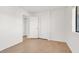A well-lit bedroom featuring wood floors, fresh paint, and a closet at 1701 E Katie Ave # 21, Las Vegas, NV 89119