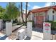 Community entrance with a unique architectural style, colorful tile roof, and lush landscaping at 1701 E Katie Ave # 21, Las Vegas, NV 89119