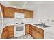 Bright kitchen with tile countertops, updated appliances, and light wood cabinetry at 1701 E Katie Ave # 21, Las Vegas, NV 89119