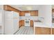 Kitchen featuring white appliances, tile countertops, and oak cabinets at 1701 E Katie Ave # 21, Las Vegas, NV 89119