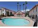 Community pool with inviting blue water and palm trees in a well-maintained complex at 1701 E Katie Ave # 21, Las Vegas, NV 89119