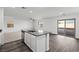 Open kitchen with an island flowing into the living room and access to outdoor patio at 1709 Desert Path Ave, North Las Vegas, NV 89032