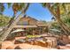 Inviting backyard featuring a pool, lounge area, and lush landscaping perfect for outdoor entertaining at 1801 Glory Creek Dr, Las Vegas, NV 89128