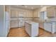 Well-lit kitchen with white cabinets, laminate counters, and a functional center island at 1808 Eagle Village Ave, Henderson, NV 89012