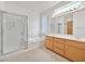 This bathroom features double sinks with a light wood cabinet, a tub and a shower at 2084 Fort Halifax St, Henderson, NV 89052