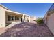 This backyard features a covered patio, perfect for outdoor living and entertaining, with gravel landscaping and a privacy wall at 2156 Twin Falls Dr, Henderson, NV 89044