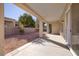 This backyard features a covered patio, perfect for outdoor living and entertaining, with gravel landscaping and a privacy wall at 2156 Twin Falls Dr, Henderson, NV 89044