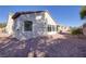 This backyard features gravel landscaping and a privacy wall; ideal for relaxation and outdoor enjoyment at 2156 Twin Falls Dr, Henderson, NV 89044