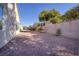 This backyard features gravel landscaping and a privacy wall; ideal for relaxation and outdoor enjoyment at 2156 Twin Falls Dr, Henderson, NV 89044