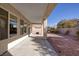 This backyard features a covered patio, perfect for outdoor living and entertaining, with gravel landscaping and a privacy wall at 2156 Twin Falls Dr, Henderson, NV 89044