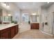 Bright bathroom features double sinks, a soaking tub, and a glass-enclosed shower at 2156 Twin Falls Dr, Henderson, NV 89044