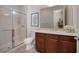 Bathroom featuring glass shower, tile flooring, and wooden cabinets at 2156 Twin Falls Dr, Henderson, NV 89044