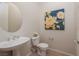 Bathroom featuring pedestal sink, tile flooring, and unique artwork at 2156 Twin Falls Dr, Henderson, NV 89044