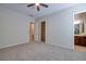 Bedroom featuring carpet, ceiling fan, and attached bathroom and closet at 2156 Twin Falls Dr, Henderson, NV 89044