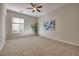 Neutral bedroom with carpet, ceiling fan, and a large window at 2156 Twin Falls Dr, Henderson, NV 89044