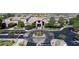 Beautiful community center entrance with a roundabout and lush landscaping at 2156 Twin Falls Dr, Henderson, NV 89044
