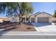 Charming single-story home featuring a three-car garage, neutral tones, and desert landscaping at 2156 Twin Falls Dr, Henderson, NV 89044
