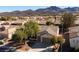 This inviting home features a two-car garage, desert landscaping, and mature shade trees, enhancing its curb appeal at 2156 Twin Falls Dr, Henderson, NV 89044