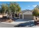 Attractive single-story home featuring a three-car garage and desert landscaping at 2156 Twin Falls Dr, Henderson, NV 89044