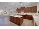 An open kitchen with an island, and warm wood cabinets, blending style and functionality at 2156 Twin Falls Dr, Henderson, NV 89044