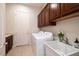 Laundry room with tile flooring, a sink, and white appliances at 2156 Twin Falls Dr, Henderson, NV 89044