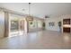 Spacious living room with sliding glass doors, tile flooring, and a ceiling fan at 2156 Twin Falls Dr, Henderson, NV 89044