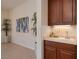 View of the wet bar featuring warm wood cabinets, a sink, and an elegant 'Cheers' sign, adding a touch of charm at 2156 Twin Falls Dr, Henderson, NV 89044