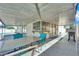 Covered patio with outdoor dining area and a pass-through bar to the house overlooking the pool at 2302 Wagonwheel Ave, Las Vegas, NV 89119