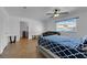 Bright bedroom with wood floors, ceiling fan, and a comfortable bed, offering a peaceful retreat at 2302 Wagonwheel Ave, Las Vegas, NV 89119