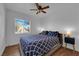 Inviting bedroom with natural light, ceiling fan, and a cozy bed, ideal for relaxation and rest at 2302 Wagonwheel Ave, Las Vegas, NV 89119