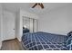 Cozy bedroom with hardwood floors, mirrored closet, and a comfortable bed, creating a serene atmosphere at 2302 Wagonwheel Ave, Las Vegas, NV 89119