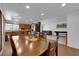 Dining area featuring a wood table, laminate floors, and an open-concept kitchen at 2302 Wagonwheel Ave, Las Vegas, NV 89119