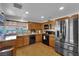 Well-lit kitchen with stainless steel appliances and wood cabinets, offering a modern and functional space at 2302 Wagonwheel Ave, Las Vegas, NV 89119