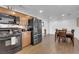 Modern kitchen featuring stainless steel refrigerator and black appliances adjacent to a dining area at 2302 Wagonwheel Ave, Las Vegas, NV 89119