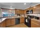 Updated kitchen with stainless steel appliances and wood cabinets, perfect for cooking and entertaining at 2302 Wagonwheel Ave, Las Vegas, NV 89119