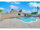 Inviting swimming pool surrounded by concrete, with a covered patio area, set against a blue sky at 2302 Wagonwheel Ave, Las Vegas, NV 89119