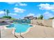 Beautiful backyard with a sparkling swimming pool, blue accent wall and desert landscaping at 2302 Wagonwheel Ave, Las Vegas, NV 89119