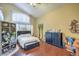Bright bedroom with wood floors, vaulted ceilings, with a decorative folding screen and dresser at 2700 Brienza Way, Las Vegas, NV 89117