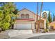 Charming two-story home with a tile roof, two-car garage, and desert landscaping in front yard at 2700 Brienza Way, Las Vegas, NV 89117