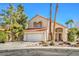 Charming two-story home boasts a tile roof, desert landscaping, and an attached two-car garage at 2700 Brienza Way, Las Vegas, NV 89117