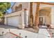 Charming two-story home boasts a tile roof, desert landscaping, and an attached two-car garage at 2700 Brienza Way, Las Vegas, NV 89117